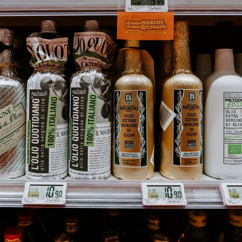 bottles of Italian olive oil sitting on the shelf.