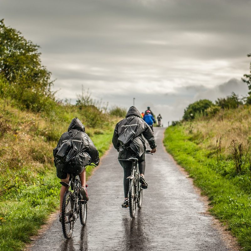 Two men riding a bicycle.