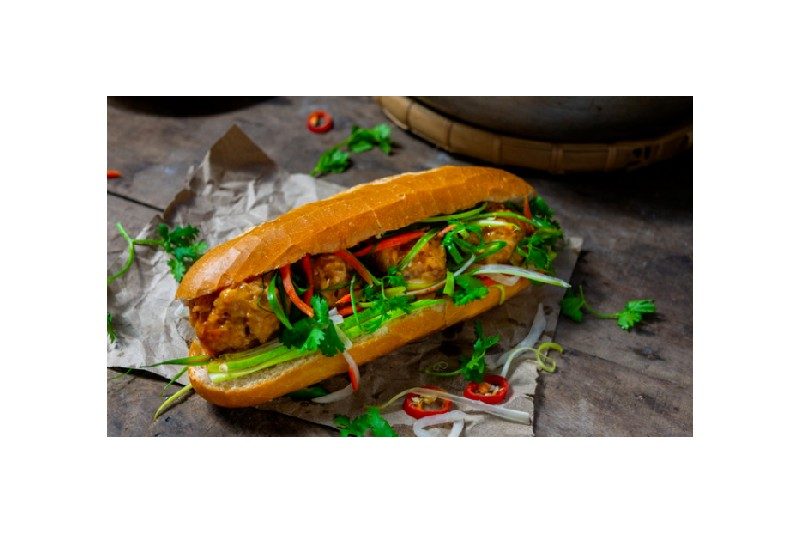 Soy-chili glazed pork meatball bahn mi on a table.