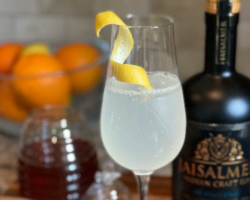 Sunshine 75 Cocktail on table.