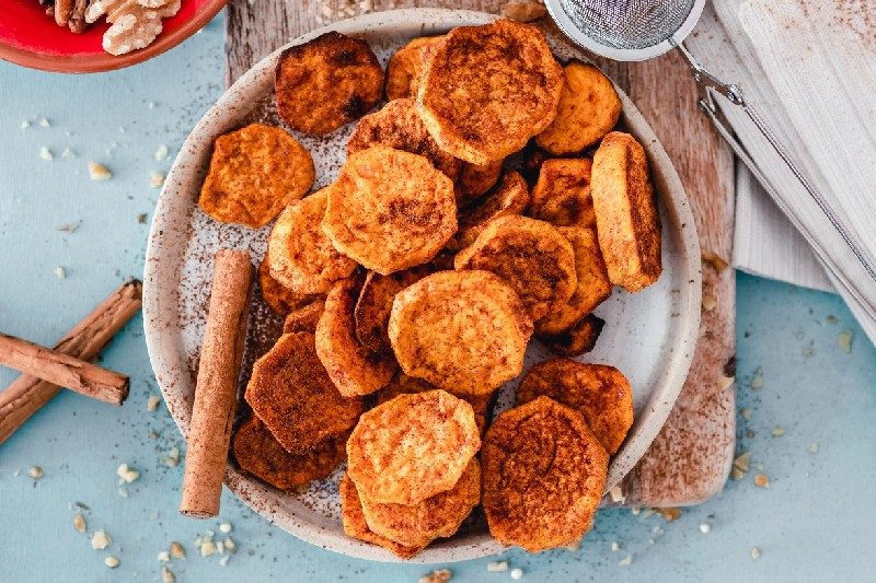 Sliced sweet potatoes with seasoning.