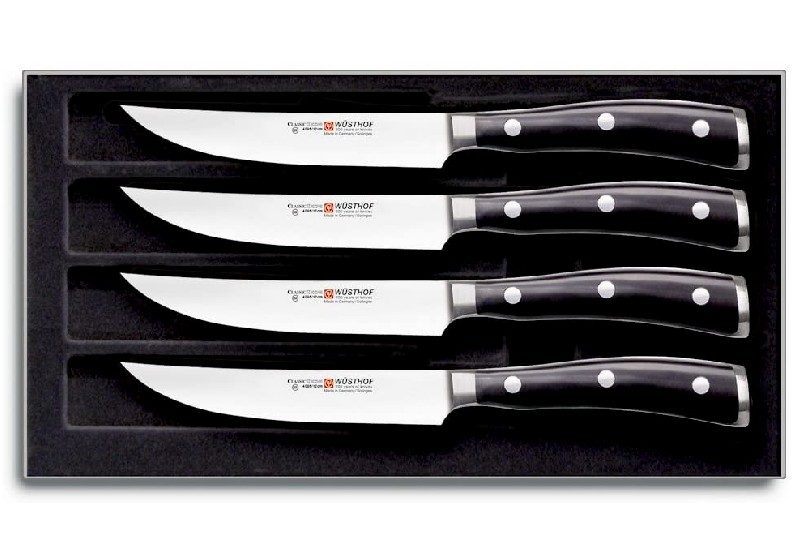 Four Wustof steak knives in a box.