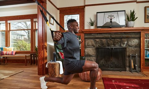 Man using TRX straps at home.