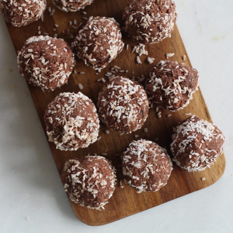 homemade protein balls on a cutting board.
