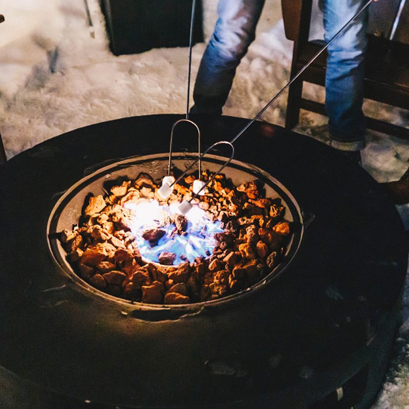 Roasting s'mores over a fire pit