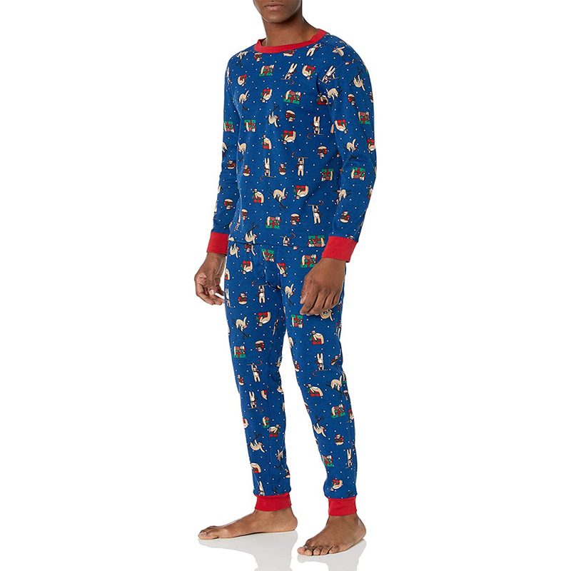 A barefooted male model wearing a blue Amazon Essentials Knit Pajama Set.