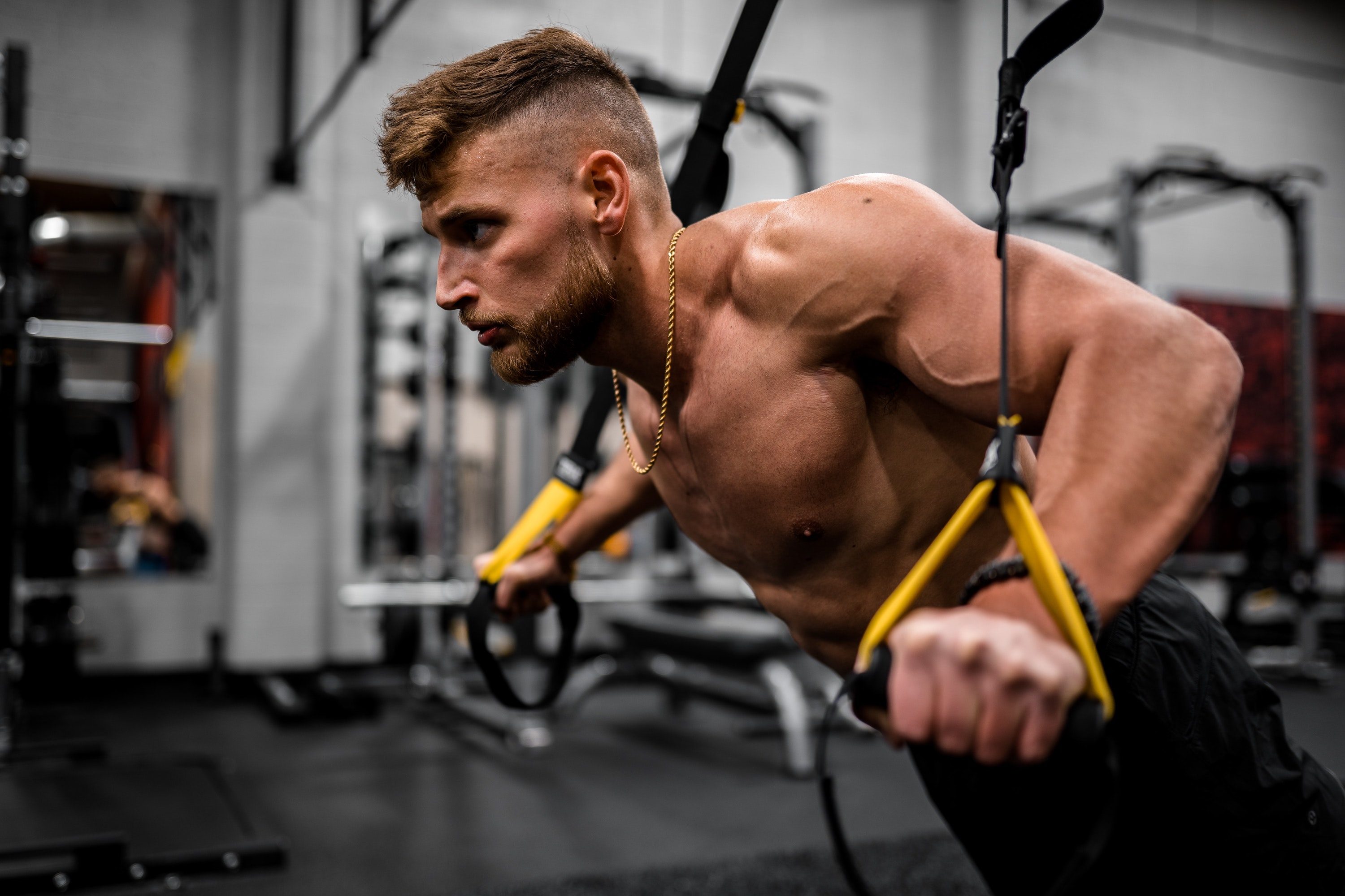 Man performing a TRX chest press.