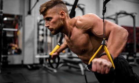 Man performing a TRX chest press.