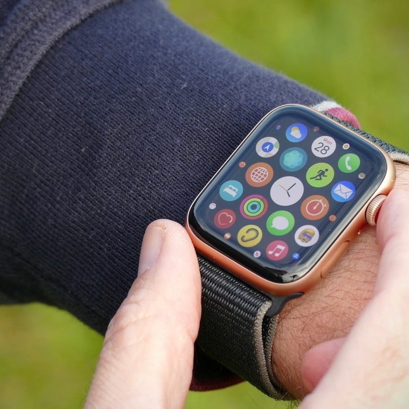 An Apple Watch SE being worn on someone's wrist with the apps displayed on its screen.