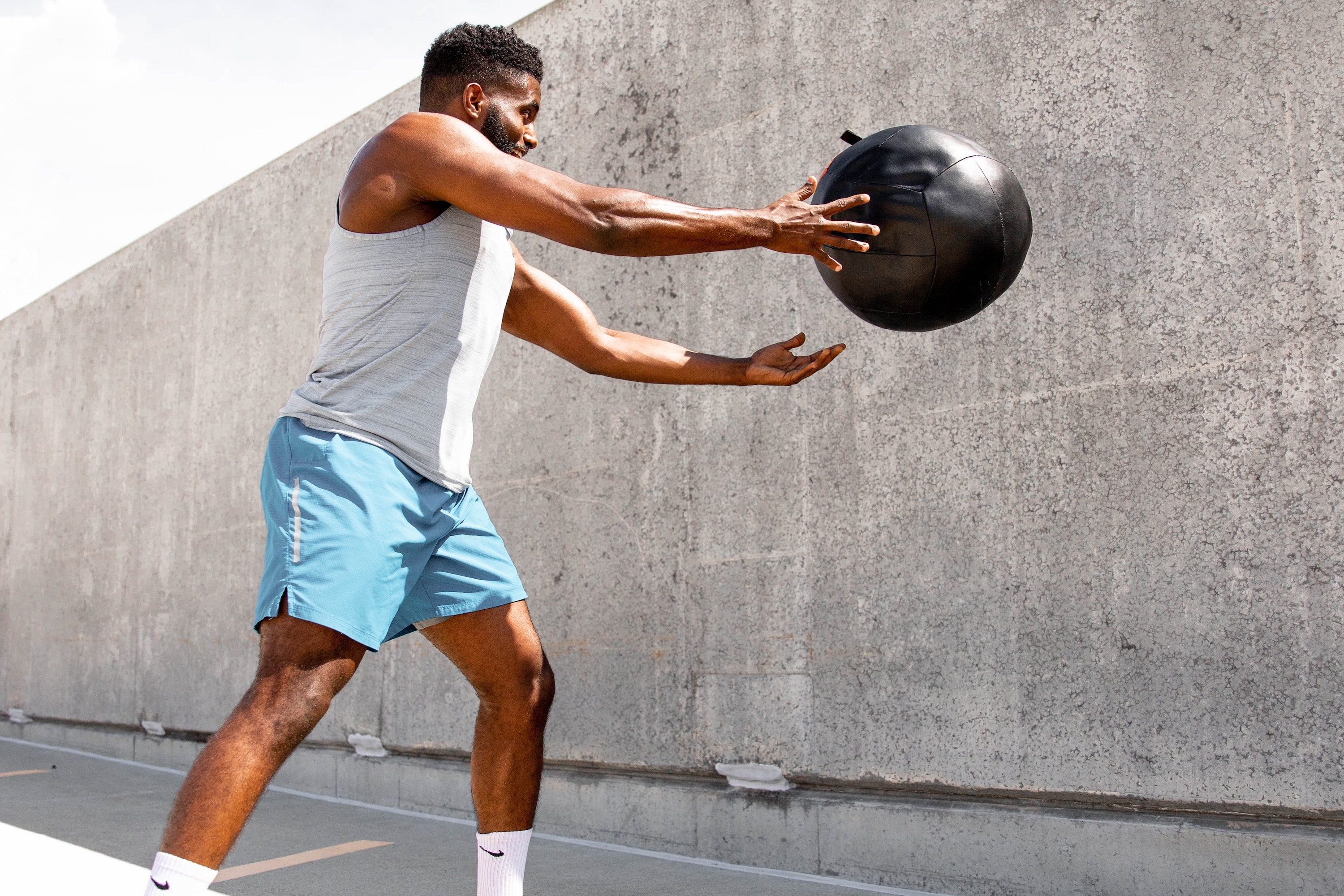 Man exercising with medicine ball.