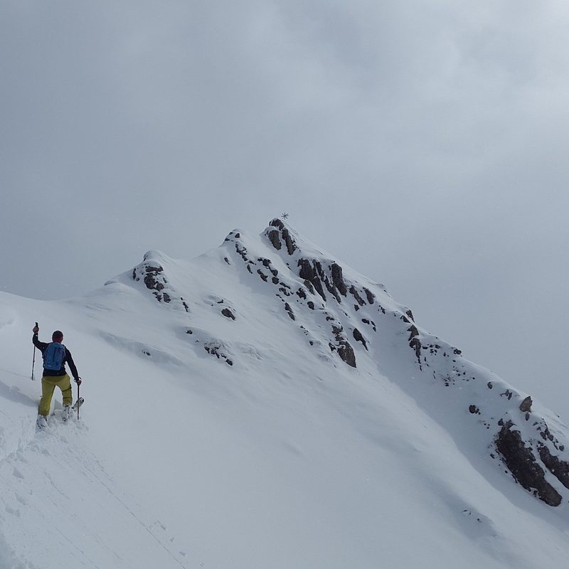 Man backcountry skiing on a mountainside.