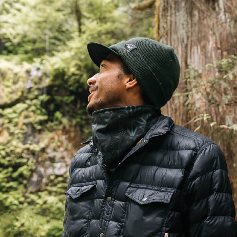 A man in the outdoors wearing a neck gaiter.