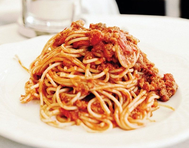 Bucatini all-Amatriciana pasta served on a white plate.