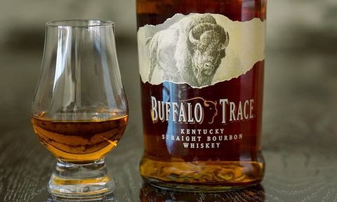A glass and a bottle of Buffalo Trace.