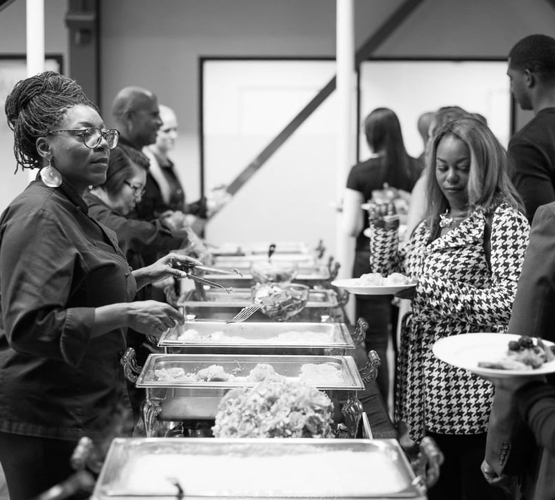 Chef Rene Johnson serving food.