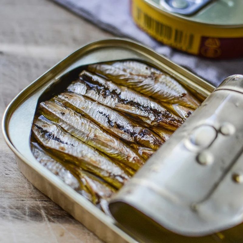 A can of opened sardines on a table