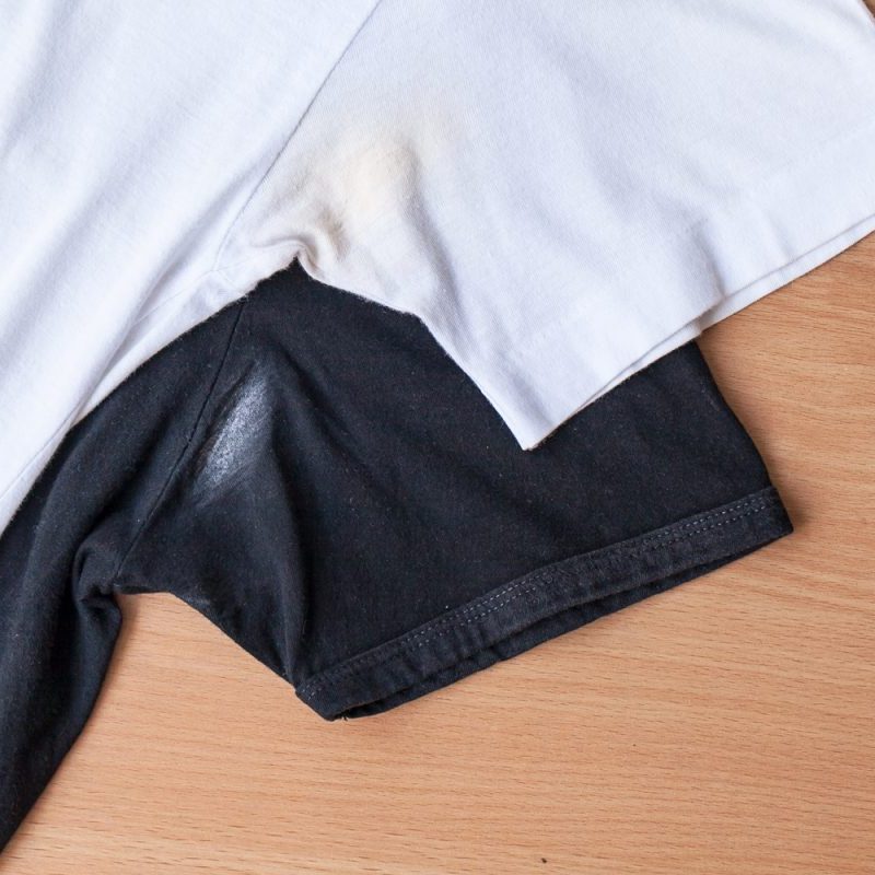 White and black shirts with deodorant stains.