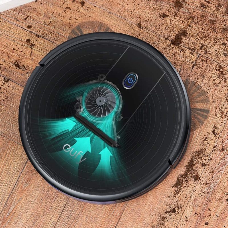 The Eufy BoostIQ RoboVac 12 robot vacuum picking up dirt.
