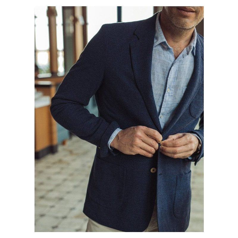 Faherty Reserve Knit Summer Blazer over a blue button down polo.