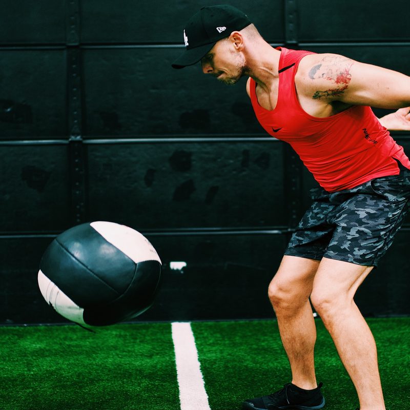 Man tossing medicine ball.