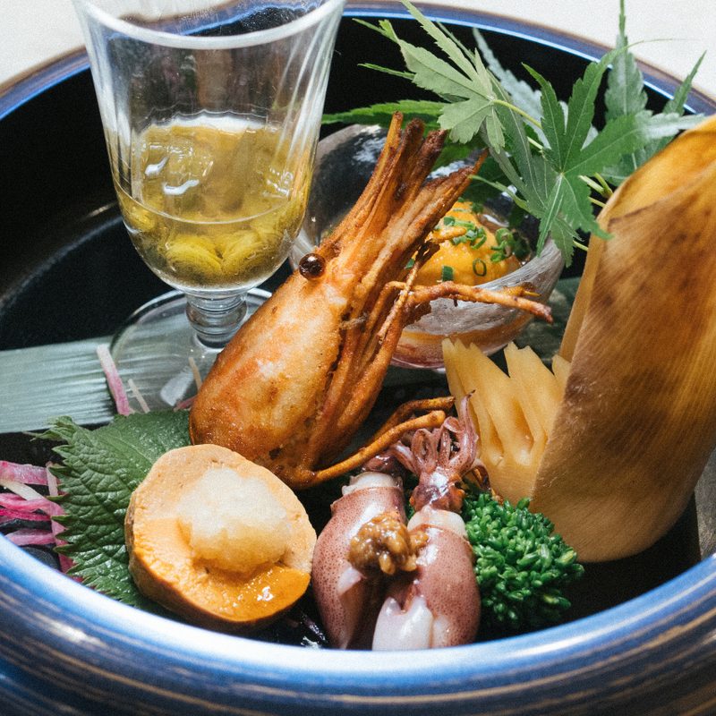 The hassun course at Koyo with various seafood items in a shallow bowl.