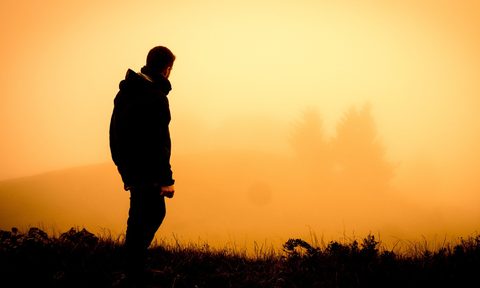 HIker standing in the sunrise