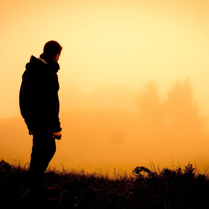 The silhouette of a hiker watching the sunrise.