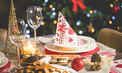 holiday snacks on the table with xmas tree in the background.