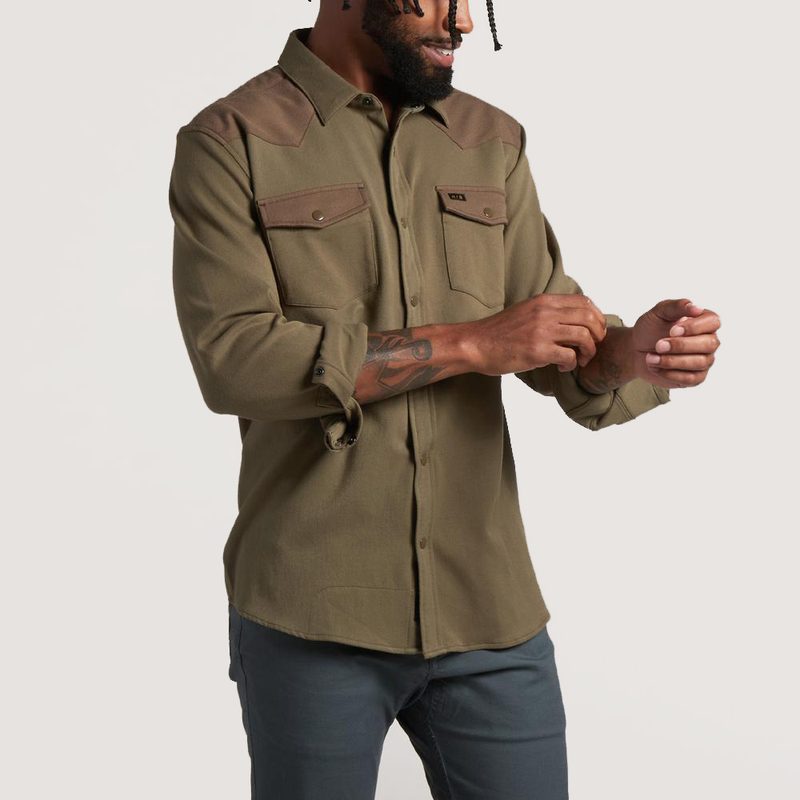 A midsection of a male model wearing jeans and Howler Brothers Stockman Stretch.