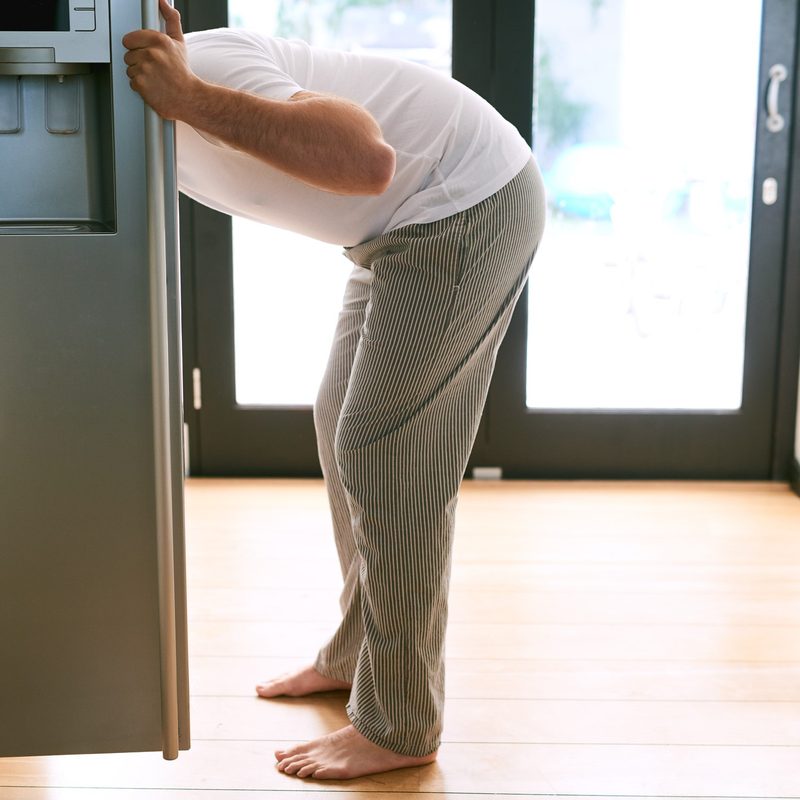 Man checking his refrigerator for food