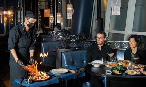 Hutong Flaming Peking duck enjoyed by diners.