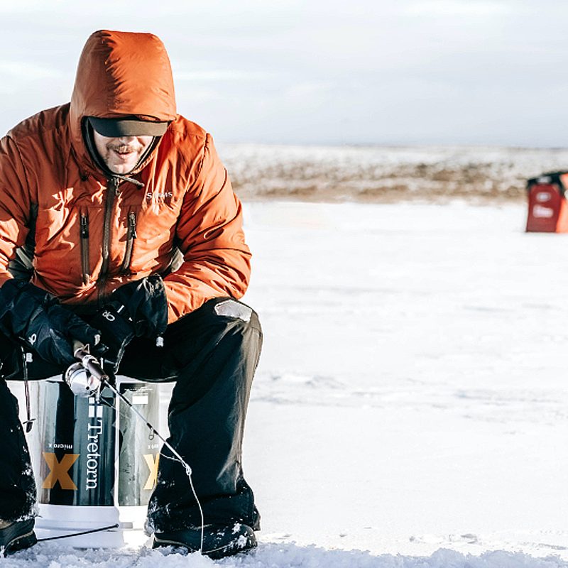 A man ice fishing.