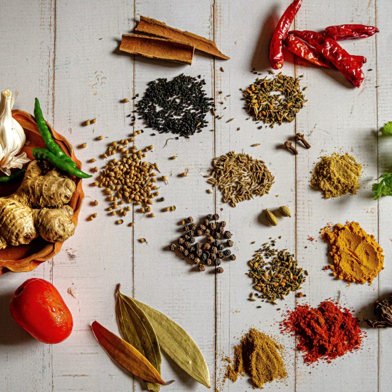 Array of Indian spices on table.
