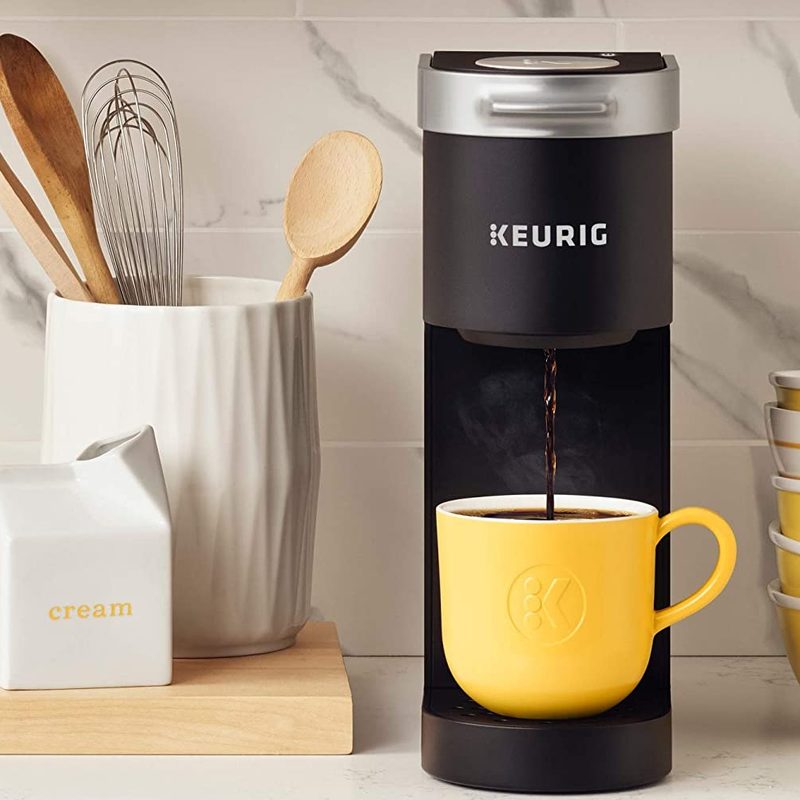 Keurig K-Mini coffee maker on a counter with accessories.