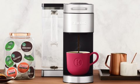 Keurig K-Supreme Plus Single Serve K-Cup Pod Coffee Maker on a counter with K-pods and cups