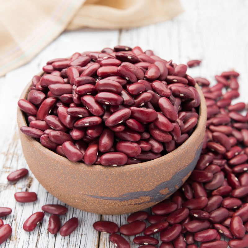 A bowl of kidney beans on a table.