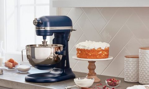 KitchenAid Pro 5 Plus 5-quart Bowl-Lift Stand Mixer sits next to a cake on a kitchen counter.