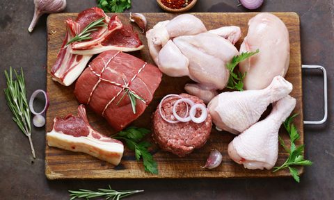 Meat and poultry served on a chopping board.