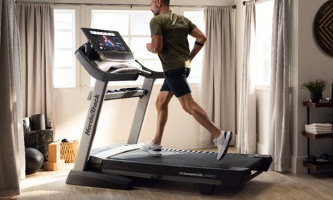A man running on a NordicTrack Commercial 2950 Treadmill.