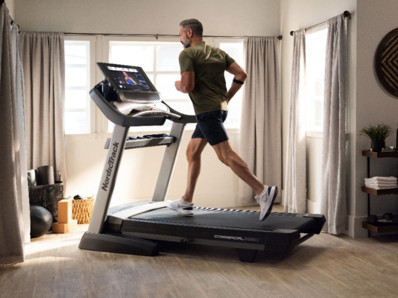 A man running on a NordicTrack Commercial 2950 Treadmill.