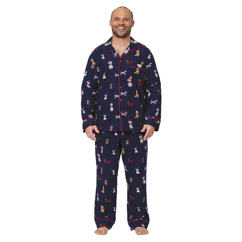 A man wearing navy pajamas with Christmas dogs print.
