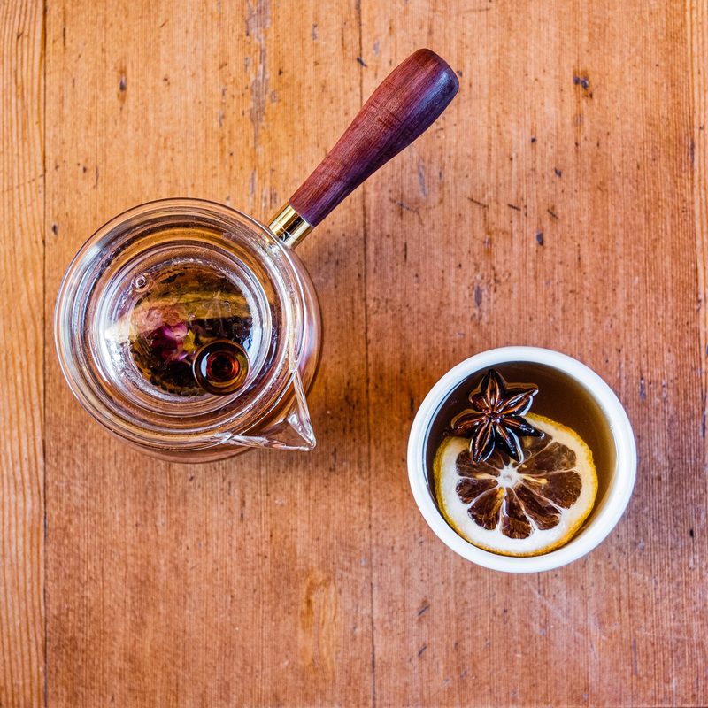 Paru Tea Hot Toddy in a mug sitting on a table.