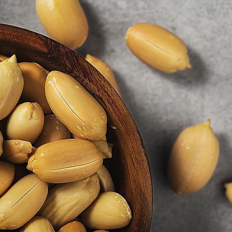 Peanuts on a wooden bowl.