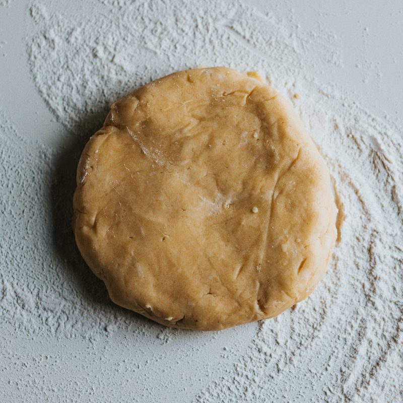 Pie Crust dusted with flour on the bottom.