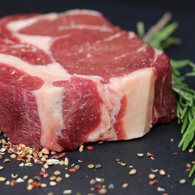 Red meat prepared with rosemary and ready to cook.