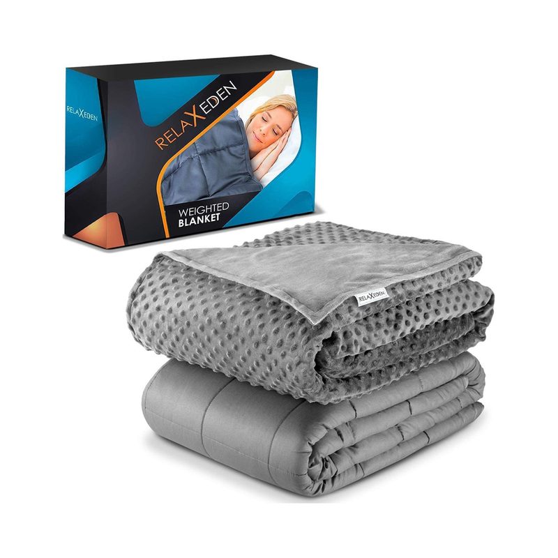 A folded RelaxEden Adult Weighted Blanket on top of its cover, with the packaging behind it.