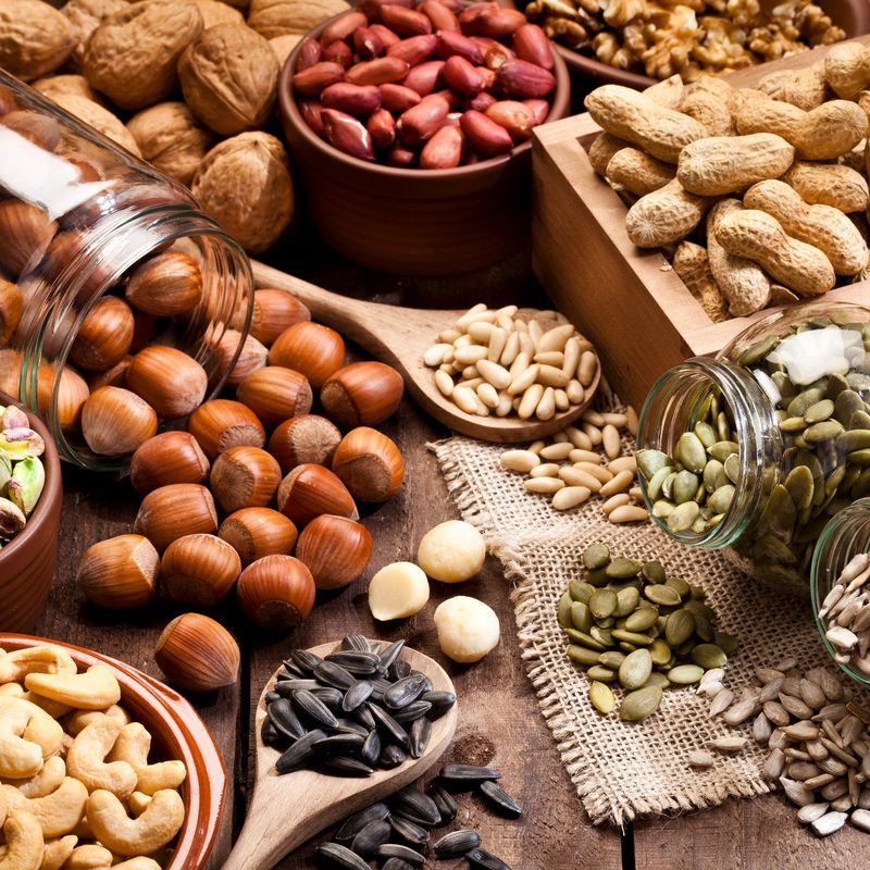 Assortment of seeds on a rustic wood table.