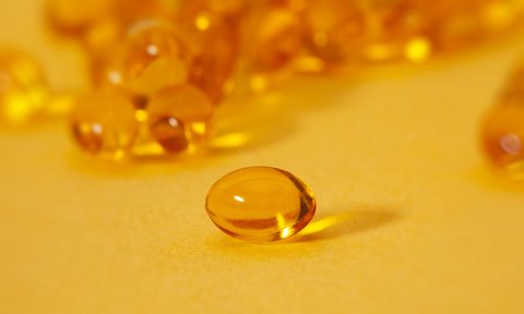 A close-up of a vitamin D capsule