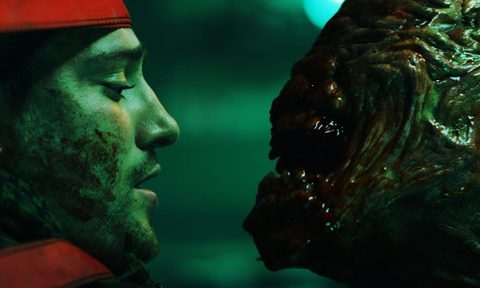 face of man and a monster staring at each other.