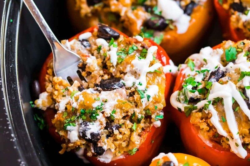 vegetarian stuffed peppers with garnish of parsley and sour cream.
